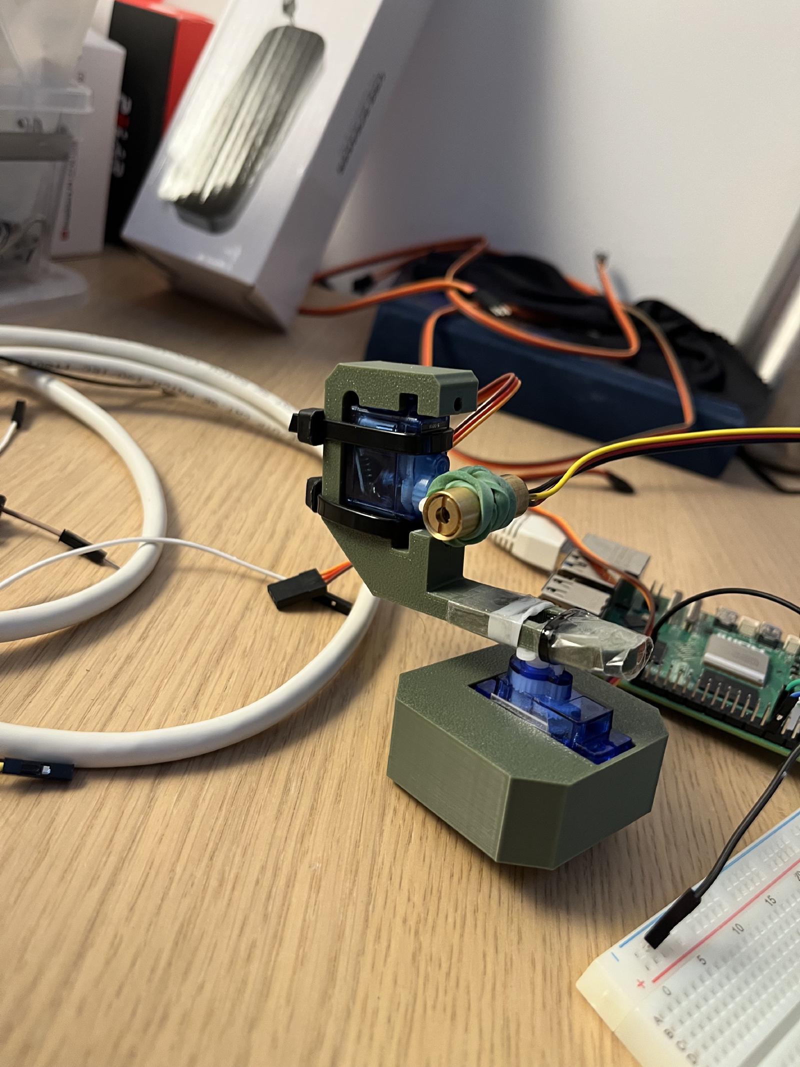 A laser is mounted onto 2 servo-motors to precisely point