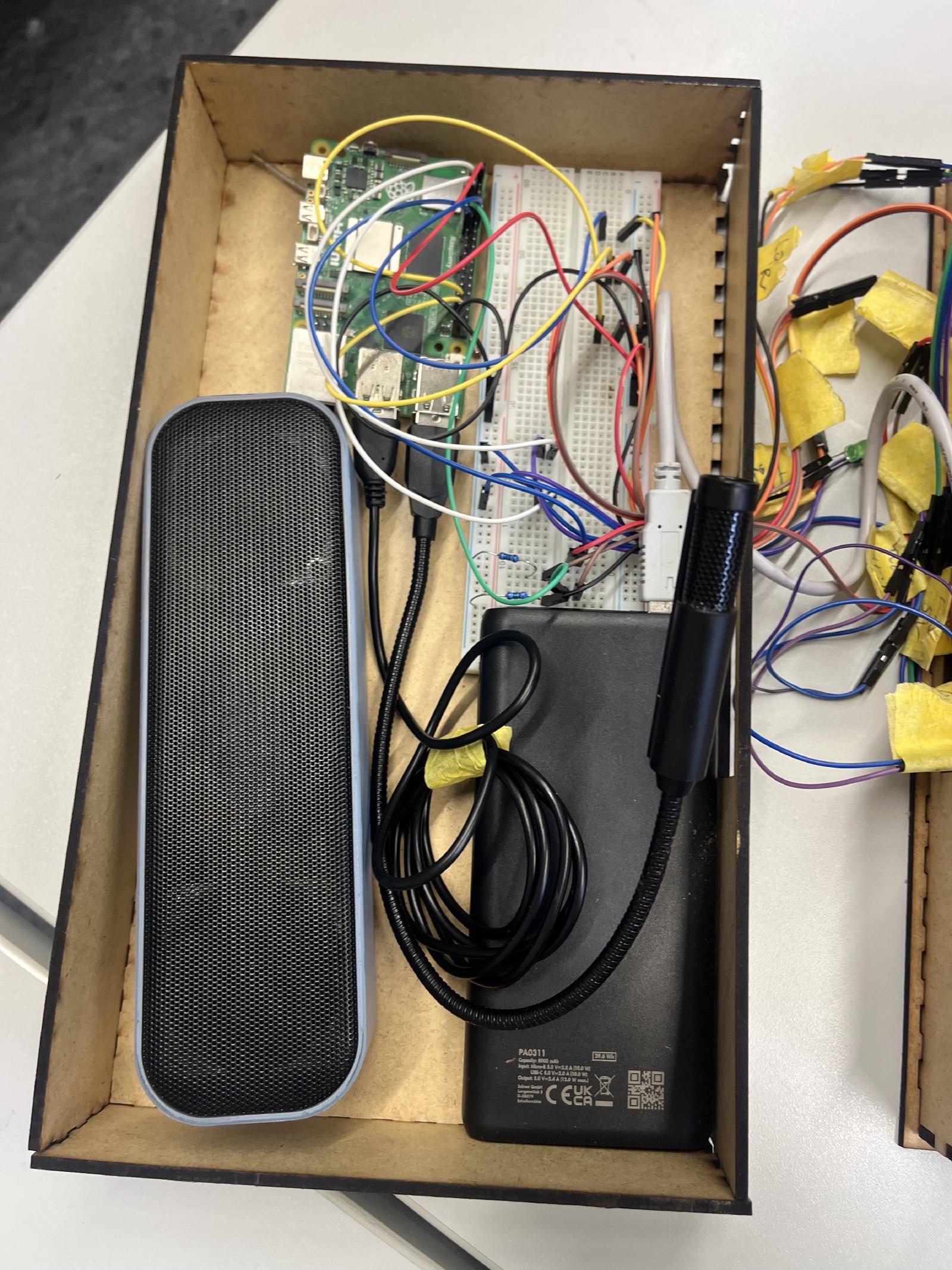 The prototype is powered by a powerbank, a raspberry pi 5, a USB-microphone & -speaker